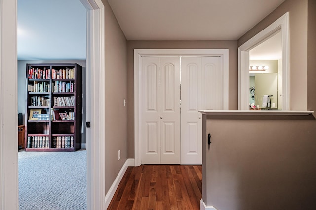 hall with dark wood finished floors and baseboards