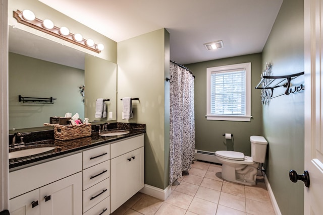 bathroom featuring toilet, baseboard heating, a sink, and tile patterned floors