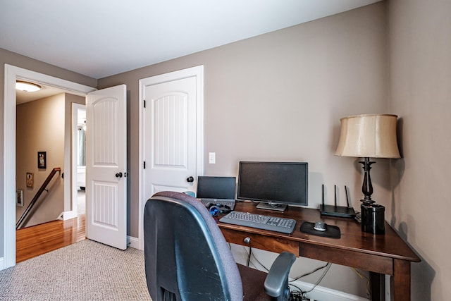 office area with light carpet and baseboards