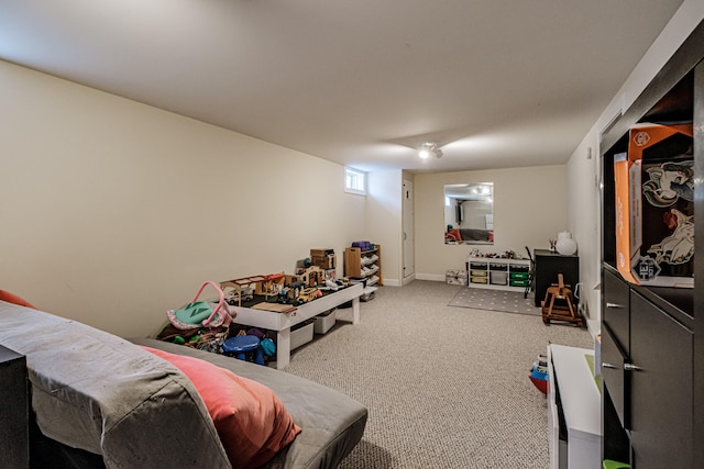 recreation room featuring baseboards and carpet flooring