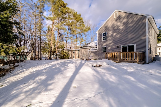 view of snow covered exterior featuring a wooden deck