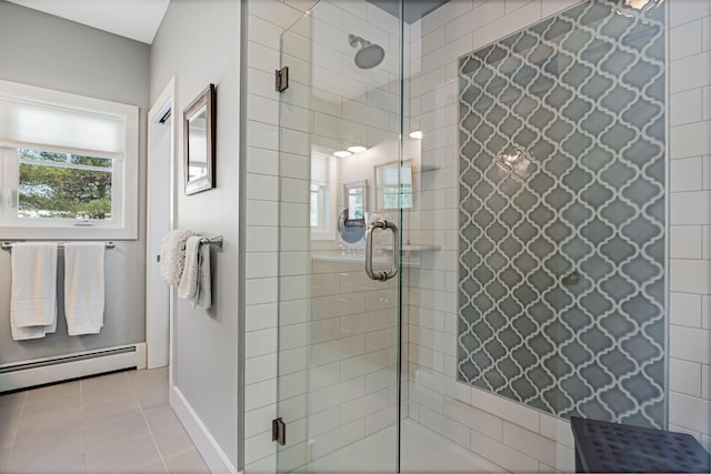 bathroom with tile patterned flooring, a shower stall, baseboards, and a baseboard radiator