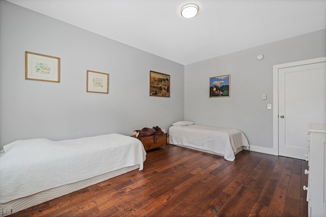 bedroom featuring baseboards and wood-type flooring