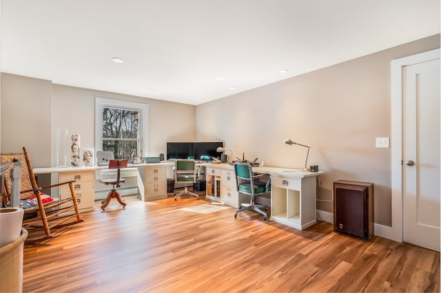 office space with light wood-style floors and baseboards