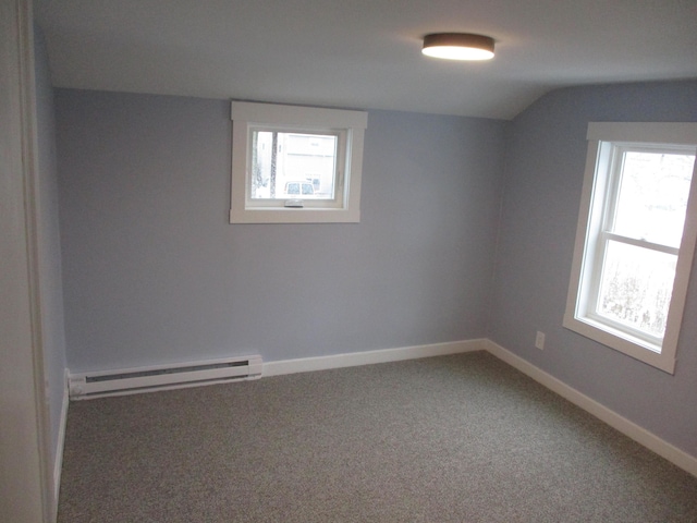 carpeted empty room with lofted ceiling, a baseboard radiator, baseboards, and a wealth of natural light