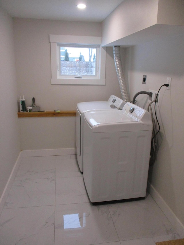 clothes washing area featuring laundry area, baseboards, marble finish floor, washing machine and dryer, and recessed lighting