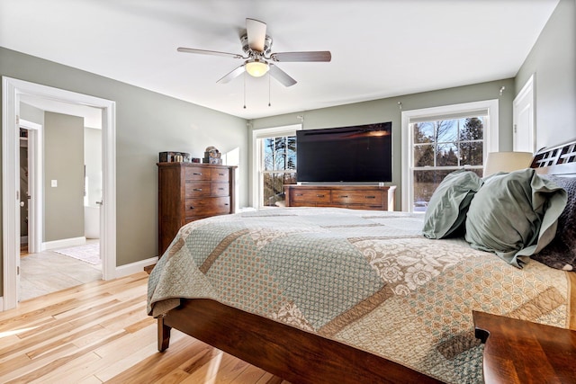 bedroom featuring light wood finished floors, ceiling fan, and baseboards