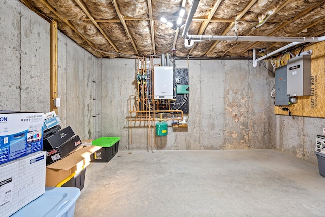 unfinished below grade area featuring electric panel and water heater