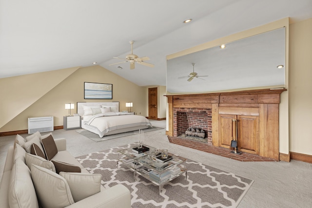carpeted bedroom featuring baseboards, vaulted ceiling, a ceiling fan, and a fireplace