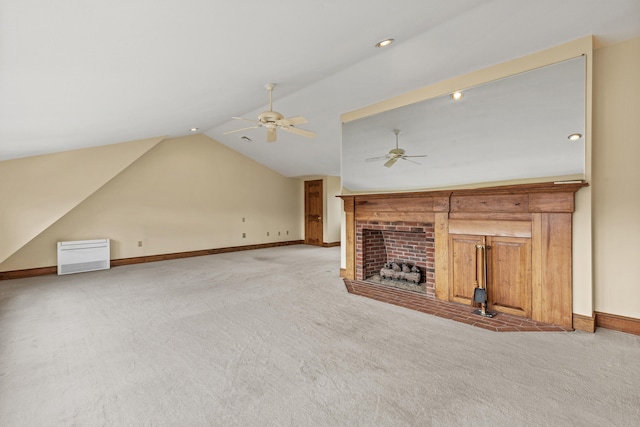 unfurnished living room featuring lofted ceiling, light carpet, baseboards, a fireplace, and ceiling fan