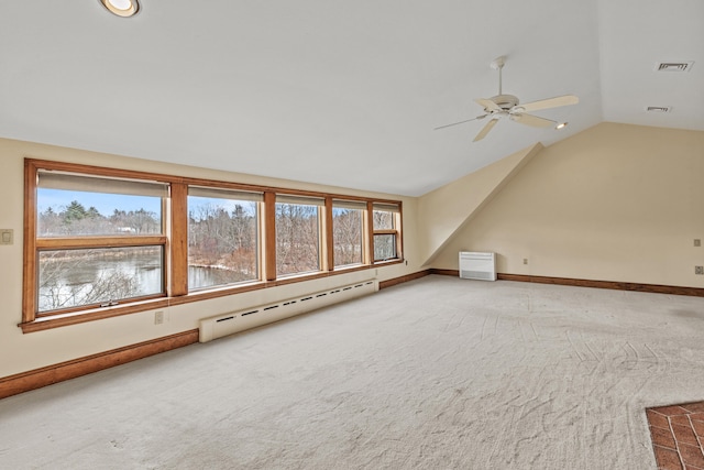 additional living space with vaulted ceiling, visible vents, a baseboard heating unit, carpet flooring, and ceiling fan
