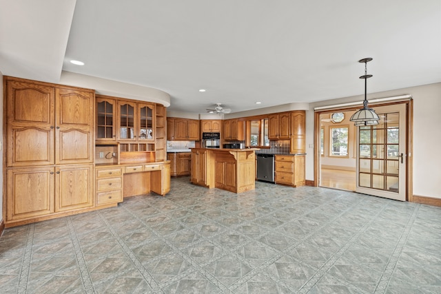 kitchen with a kitchen breakfast bar, recessed lighting, built in study area, brown cabinets, and dishwasher