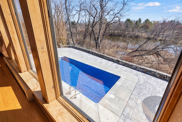 view of pool with a fenced in pool and a water view