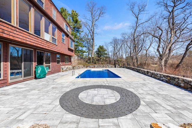 view of swimming pool with a patio area and a fenced in pool