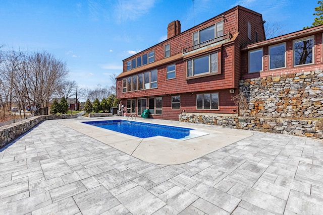outdoor pool with a patio area