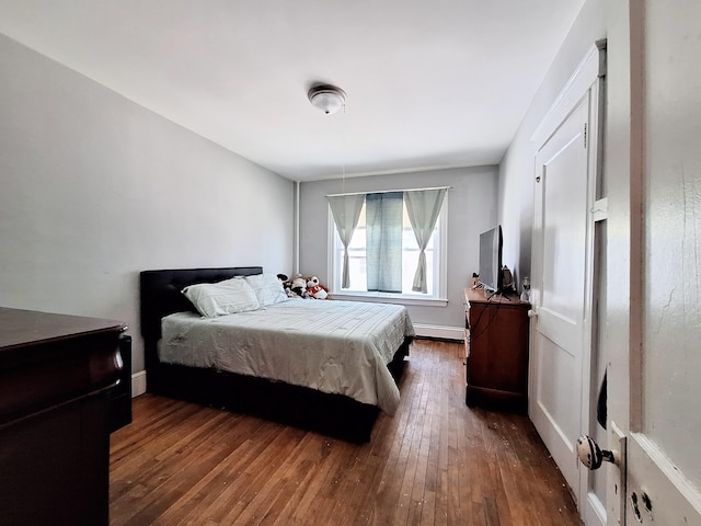 bedroom featuring a baseboard radiator and wood-type flooring