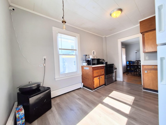 kitchen with brown cabinets, stainless steel electric range oven, a baseboard radiator, light countertops, and light wood-style floors