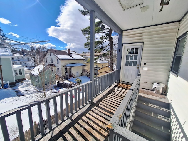 view of snow covered back of property