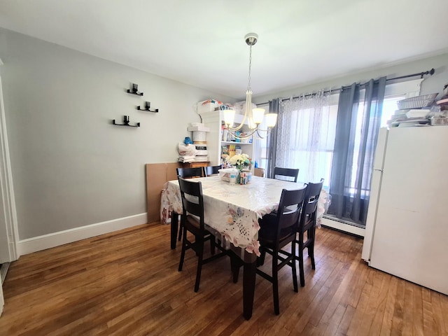 dining room featuring an inviting chandelier, a baseboard radiator, baseboards, and hardwood / wood-style floors