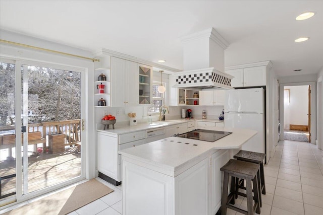 kitchen featuring a sink, open shelves, white appliances, and wall chimney range hood