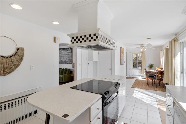 kitchen with light tile patterned floors, a baseboard radiator, black electric range, radiator, and custom range hood