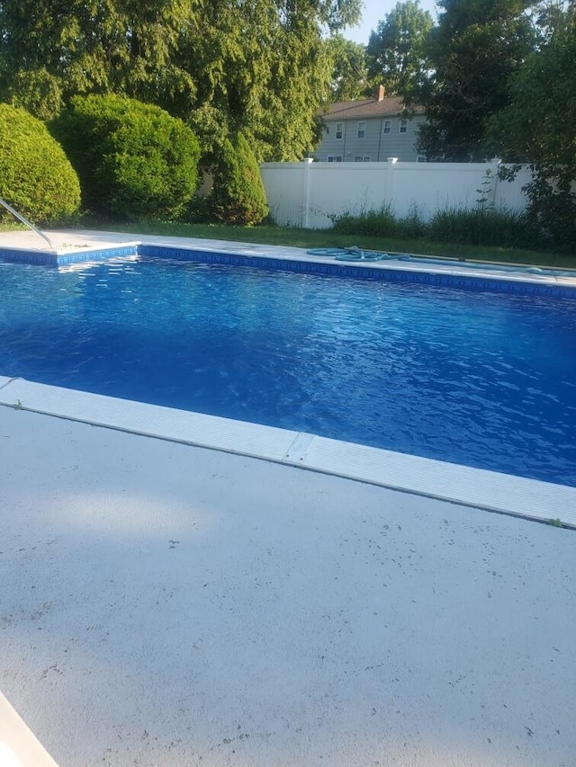 view of swimming pool featuring fence and a fenced in pool