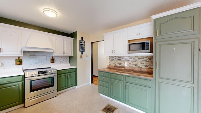 kitchen featuring white cabinets, premium range hood, green cabinetry, and stainless steel appliances