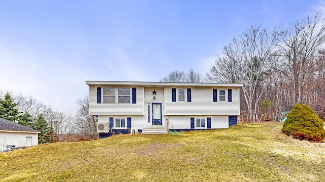 split foyer home with ac unit, entry steps, and a front yard