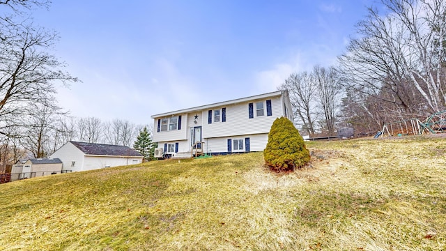 bi-level home with a front yard and a playground