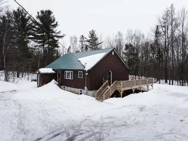 exterior space with a deck and a detached garage