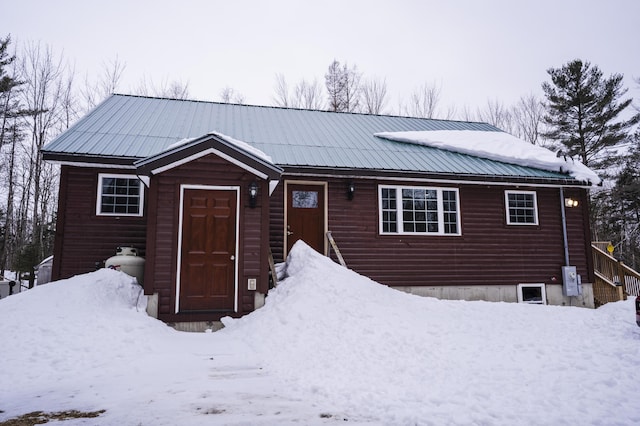 rustic home featuring metal roof and log veneer siding