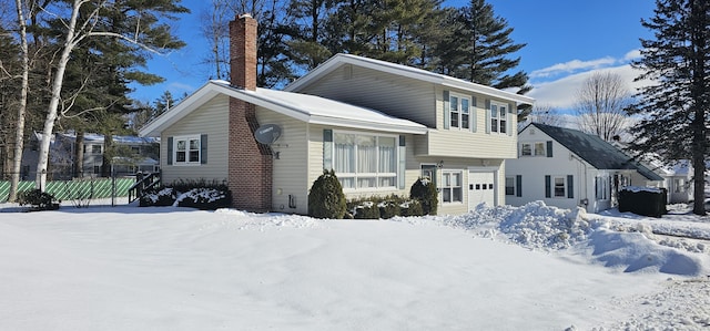 view of front of property featuring a chimney and fence