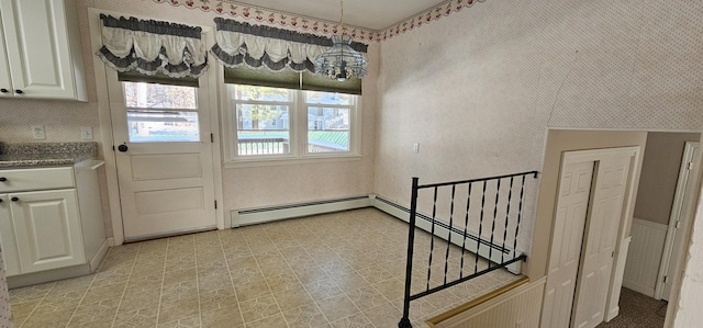 interior space featuring wallpapered walls, a baseboard radiator, and light floors