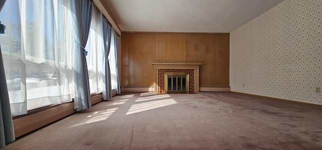 unfurnished living room with a baseboard radiator, a brick fireplace, carpet, and wallpapered walls