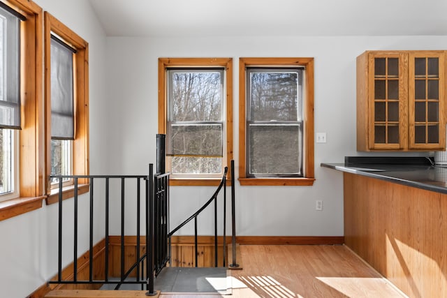 unfurnished dining area featuring baseboards and wood finished floors