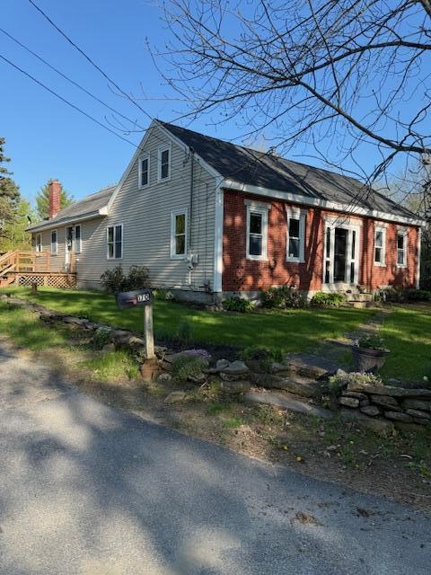 170 Hathaway Rd, Winthrop, ME 04364 - view of front facade with a front lawn, a chimney, and a deck