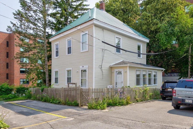 view of front of home featuring a fenced front yard and a chimney