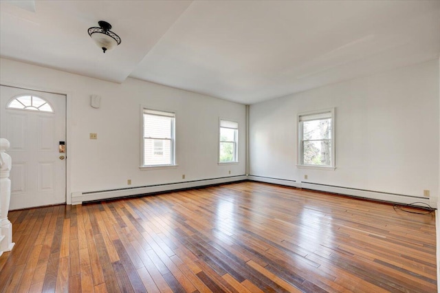 entryway with a baseboard radiator and hardwood / wood-style flooring