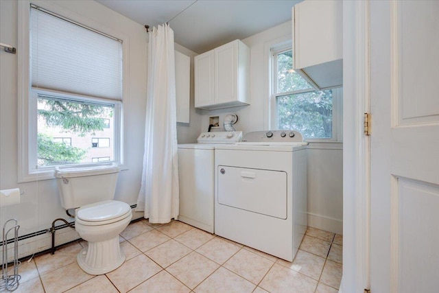 washroom featuring a baseboard heating unit, washing machine and clothes dryer, and light tile patterned floors