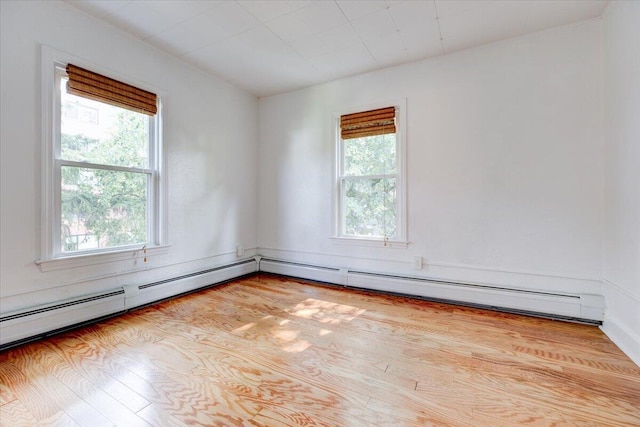 empty room with a healthy amount of sunlight and wood finished floors