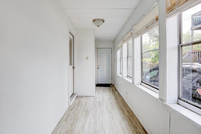 interior space featuring light wood-type flooring and baseboards