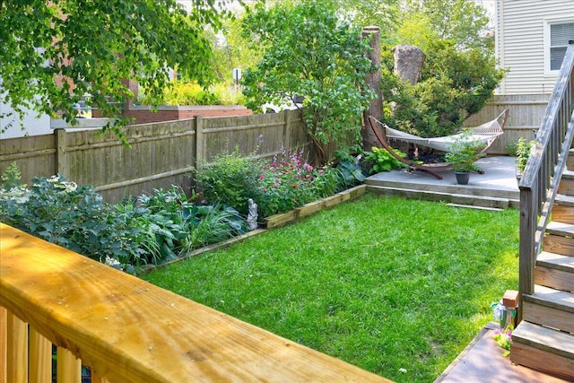 view of yard featuring fence and a vegetable garden