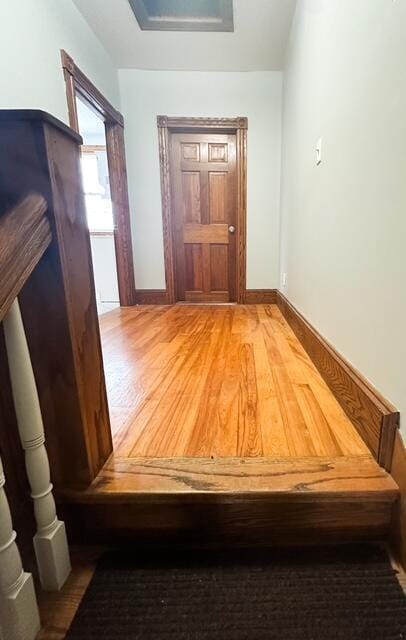 hallway with light wood-style flooring and baseboards