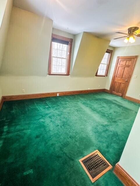 bonus room featuring a wealth of natural light, carpet flooring, visible vents, and baseboards