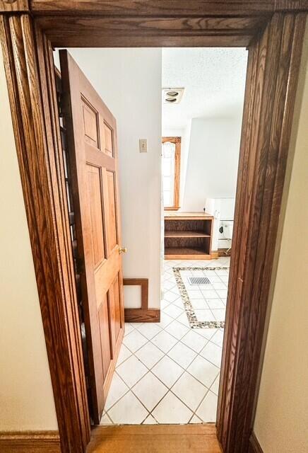 hallway featuring light tile patterned floors