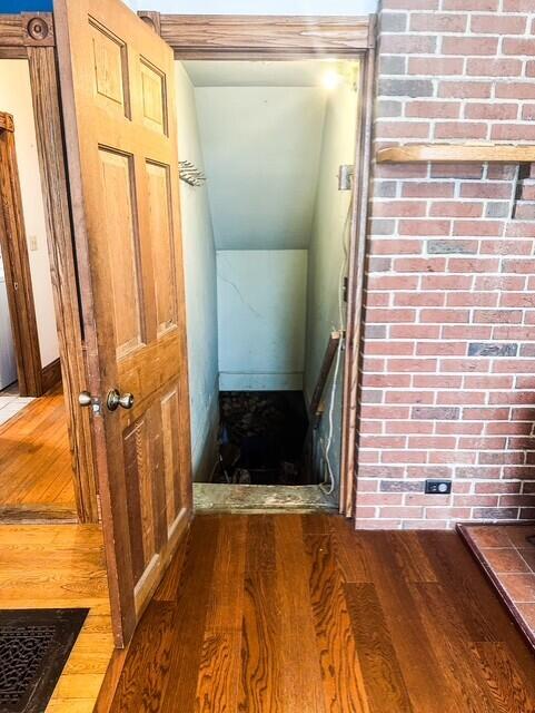 stairway featuring lofted ceiling and wood finished floors