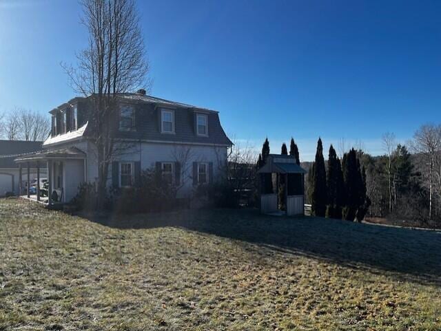 back of property with mansard roof