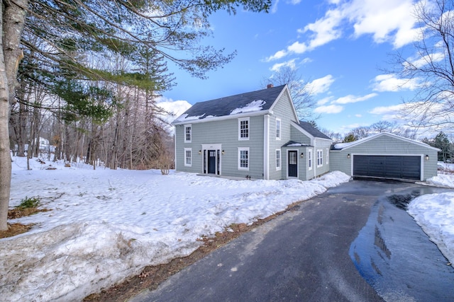 view of snow covered exterior with a garage and an outdoor structure