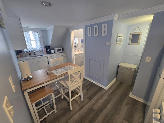 dining space featuring dark wood-style floors, baseboards, and crown molding