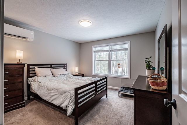 carpeted bedroom featuring a wall mounted air conditioner, a textured ceiling, and baseboards